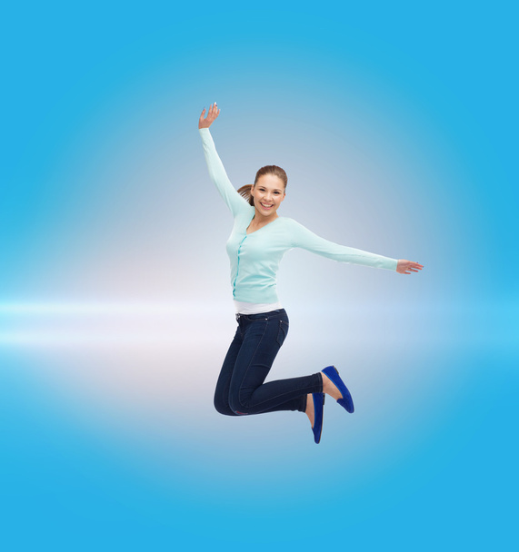 smiling young woman jumping in air - Fotografie, Obrázek