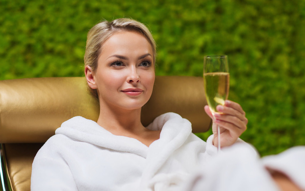 beautiful young woman drinking champagne at spa - Foto, Imagem