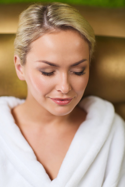 close up of woman sitting in bath robe at spa - Zdjęcie, obraz