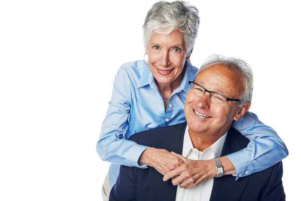 Senior couple, love and happy together for hug, support care and happiness isolated in white background studio. Elderly man, woman smile portrait and hugging, quality time romance or relax bonding. - Foto, imagen