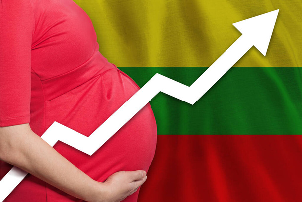 Lithuanian pregnant woman on flag of Lithuania background. Birth rate up - Photo, image