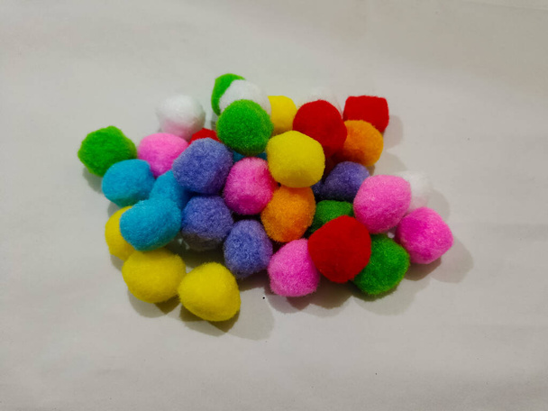 colorful pompoms on the white background. red, blue, pink, blue, and yellow color. - Photo, image
