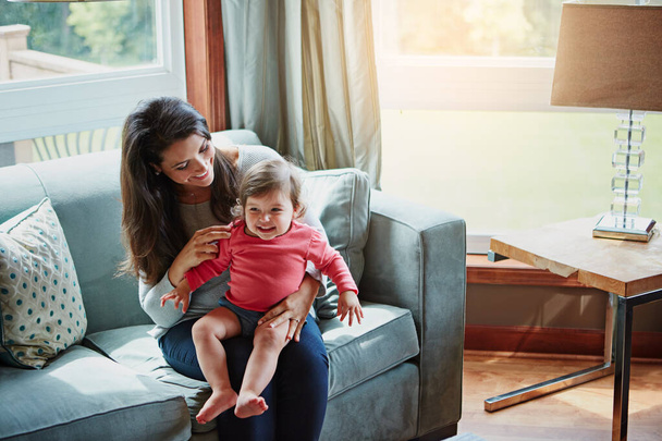 Relax, happy and smile with mother and baby on sofa for bonding, quality time and child development. Growth, support and trust with mom and daughter in family home for health, connection and care. - Photo, Image