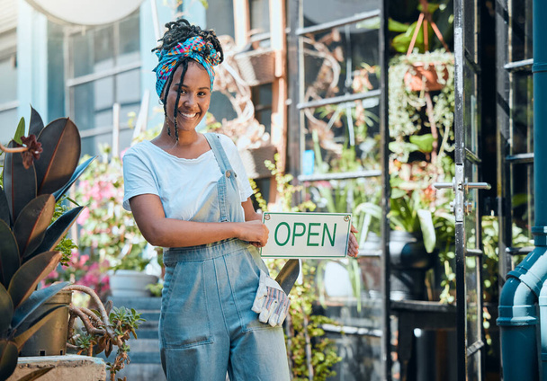 Flowers, open sign and florist portrait of woman, startup small business owner or store manager with retail sales choice. Commerce shopping service, plant market or African worker with garden product. - Foto, Imagem