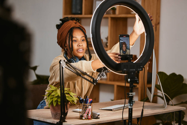 Communication, phone and influencer live streaming podcast, radio talk show or speaker talk about teen culture. Presenter microphone, black woman setup broadcast or speaking about online student news. - Fotoğraf, Görsel