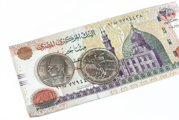 Background of old Egyptian money banknotes and coins of two hundred pounds 200 EGP LE banknote bill of Qani Bay mosque and coin of Orabi Revolution and 10 ten Egyptian piasters of king Farouk I first - Fotoğraf, Görsel
