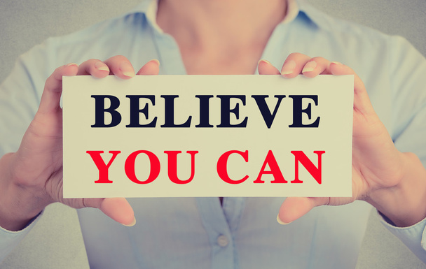 Closeup businesswoman hands holding sign with believe you can message  - Foto, Imagen