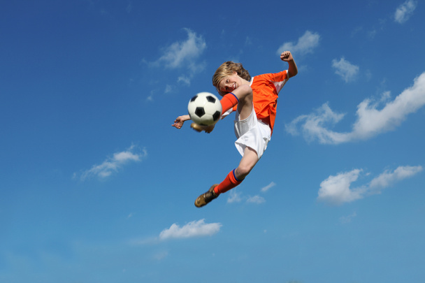 Child playing football or soccer - Foto, imagen