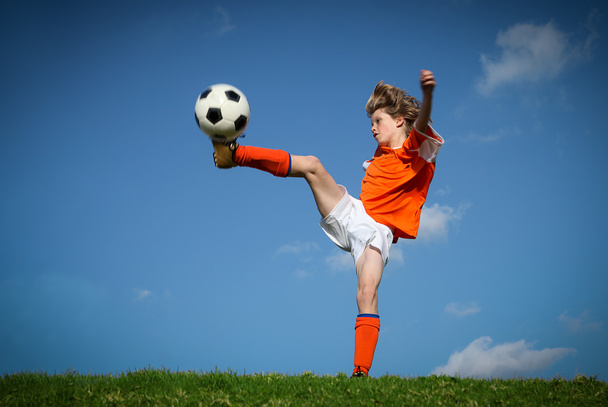 Child kicking playing football - Photo, image