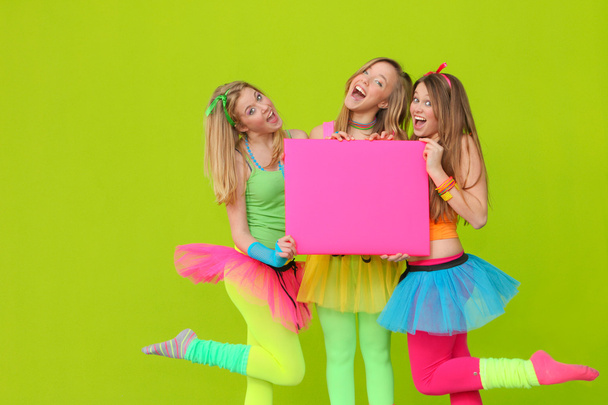 Happy party or fancy dress girls with blank board - Foto, afbeelding