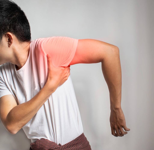 Pain in the shoulder joint and arm of Southeast Asian man. Concept of frozen shoulder. - Fotografie, Obrázek