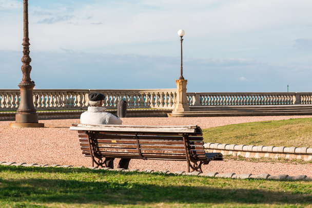 old lonely man sitting on public bench, waterside Solitude - Fotó, kép