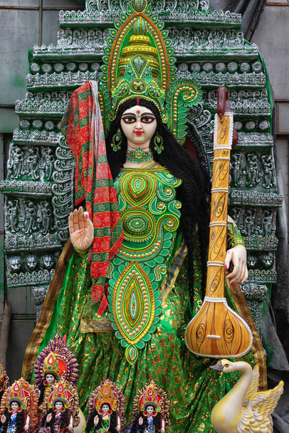 Goddess Saraswati idol is under preparation for upcoming Saraswati Puja festival at a potter's studio. Devi Saraswati is considered as the goddess of knowledge, music, art, wisdom, and learning. - Foto, imagen