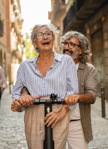 Modern senior couple with electric scooter - Fotoğraf, Görsel