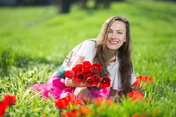 Woman with spring flowers - Fotografie, Obrázek