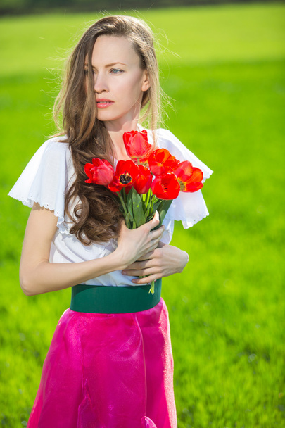 Woman with spring flowers - Фото, зображення