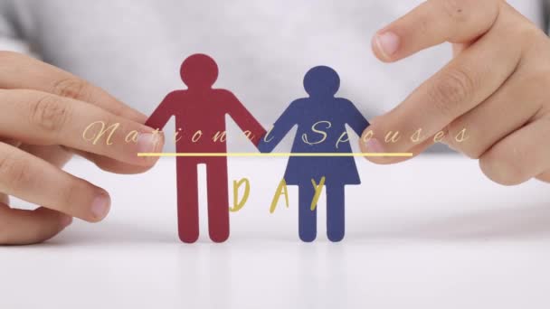 Paper cut out of female and male in the hands of a child. National Spouses Day - Materiał filmowy, wideo