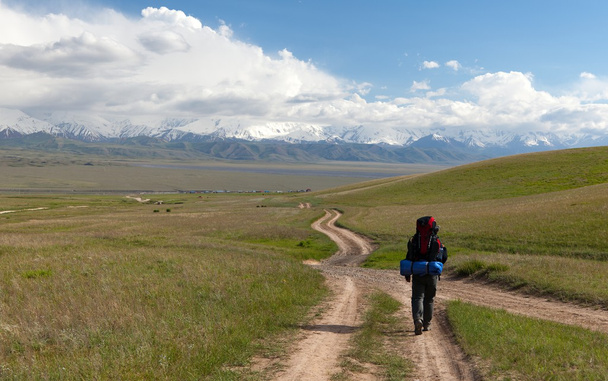 Man on way in steppe and Pamir mountains - Kyrgyzstan - Foto, imagen