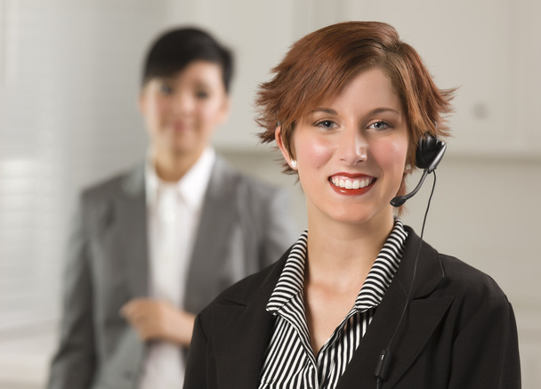 Pretty Red Haired Businesswoman with Headset in Office - Photo, Image