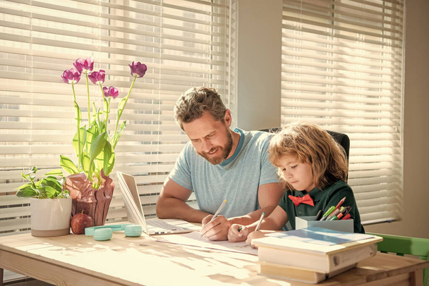 homeschooling and self-education. back to school. busy father and son painting at home. family help. boy do homework with teacher. private writing lesson. education concept. - Foto, imagen