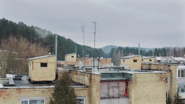 Roofs of slummy suburb area. Smoke from chimney. - Footage, Video