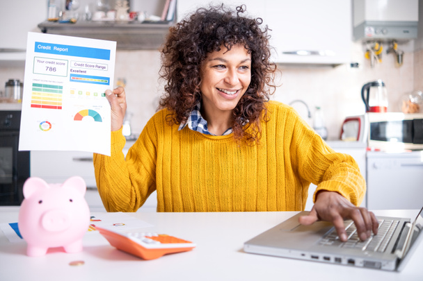 Cheerful black woman holding good credit score bank statement - Foto, Imagen