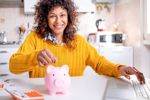 Smiling black woman saving goal for future retirement plan looking at the camera - Photo, Image