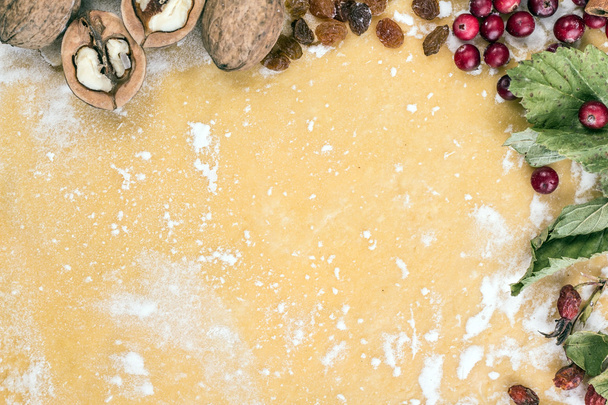 Background dough with nuts, raisins & flour - Foto, imagen