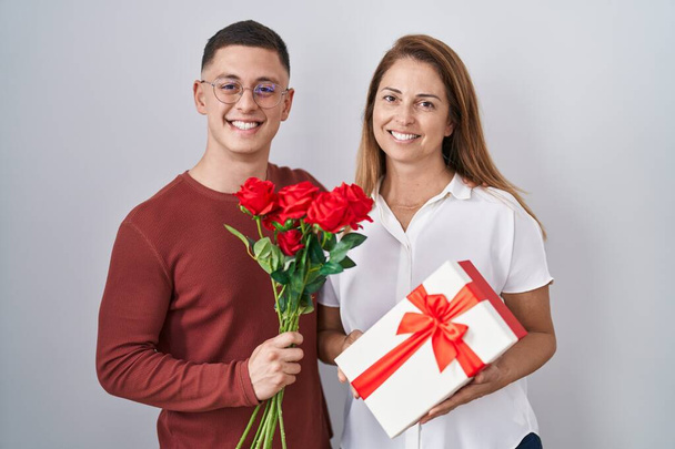 Mother and son holding mothers day gift smiling with a happy and cool smile on face. showing teeth.  - Φωτογραφία, εικόνα