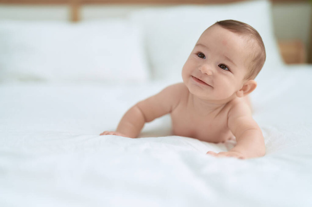 Adorable toddler smiling confident lying on bed at bedroom - Fotoğraf, Görsel