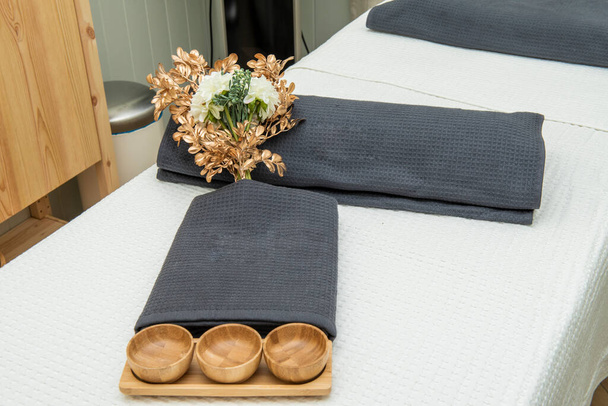 Wooden objects and towels on a massage table - Foto, imagen