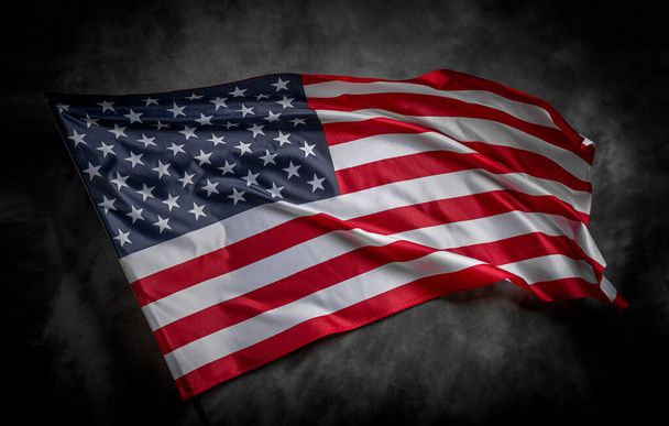 American flag on dark background. USA flag on a black background. - Fotografie, Obrázek