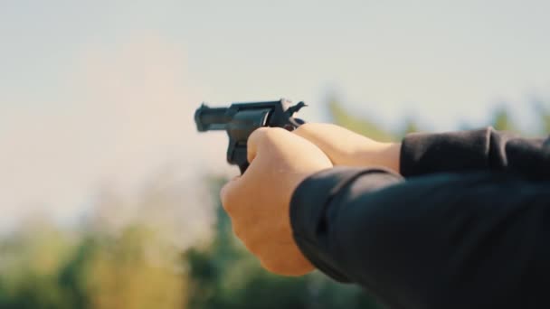 Hands of a man shooting a pistol with a revolving cylinder. High quality 4k footage - Filmati, video