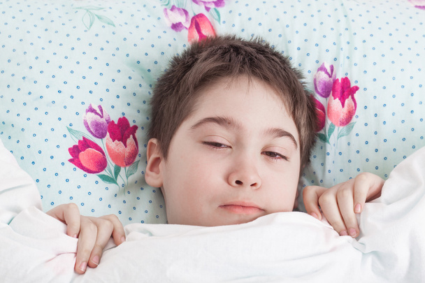 Boy lying awake in bed - Photo, Image