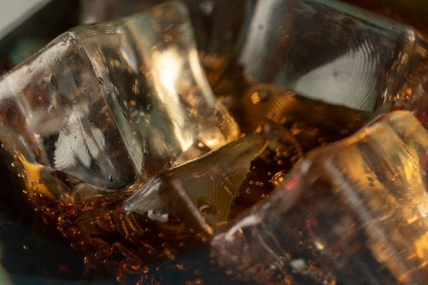 Coke or club soda poured into a glass with ice cubes - Foto, Imagem