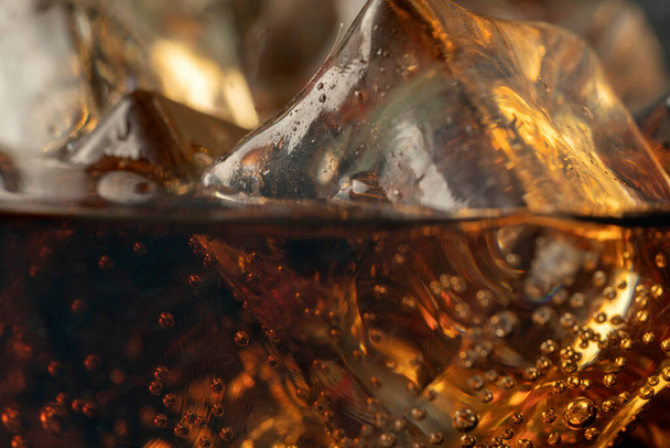 Coke or club soda poured into a glass with ice cubes - Zdjęcie, obraz