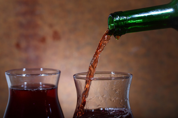 Wine flows from a bottle in a glass - Photo, Image