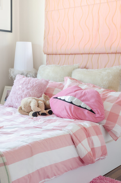 girl's bedroom in pink color with pillows and doll  - Photo, Image