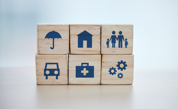 Wooden, cubes or stack in house risk management, security or future protect on background desk mockup or home table. Zoom, building blocks or life insurance in medical, car loan or mock up cog wheel. - Photo, Image