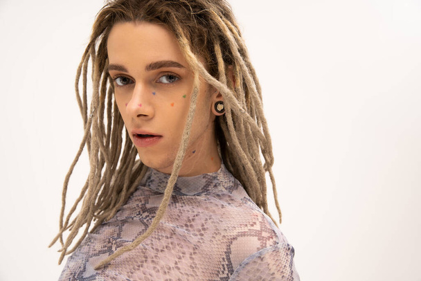 Portrait of tattooed queer person with dreadlocks hairstyle isolated on white  - Fotografie, Obrázek