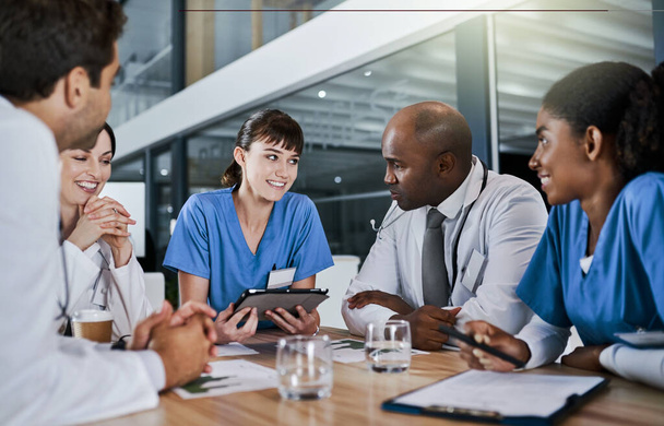Putting their patients wellness on the agenda. a group of doctors having a meeting in a hospital - Foto, Imagen