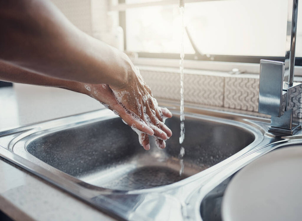 Cleaning, health or washing hands in kitchen with soap for skincare, self care or hygiene with tap water. Safety, zoom or healthy person at a sink for liquid protection against bacteria after cooking. - Foto, afbeelding