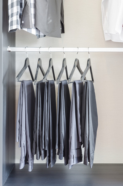row of black pants hangs in wardrobe - Photo, Image