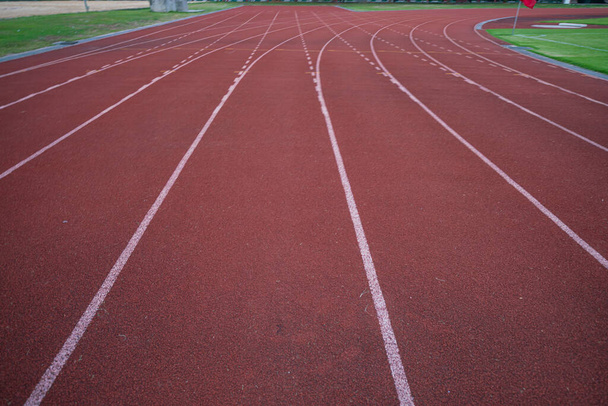 Empty fast running lane in outdoor sport stadium running track - Fotoğraf, Görsel