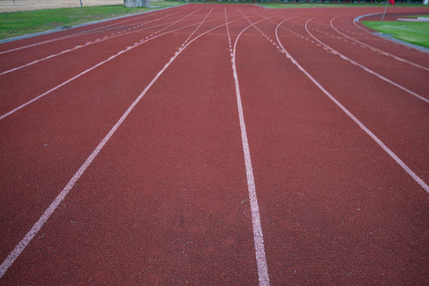 Empty fast running lane in outdoor sport stadium running track - Fotoğraf, Görsel