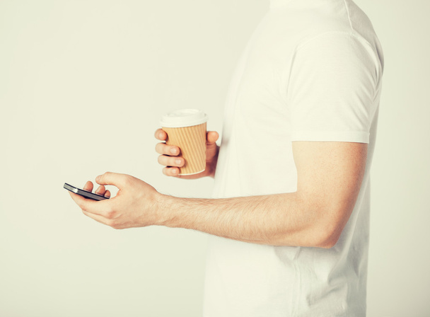 man with smartphone and coffee - Фото, зображення