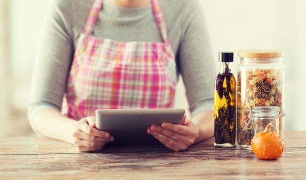 closeup of woman reading recipe from tablet pc - Photo, Image