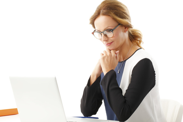 Businesswoman sitting in front of laptop - Photo, image
