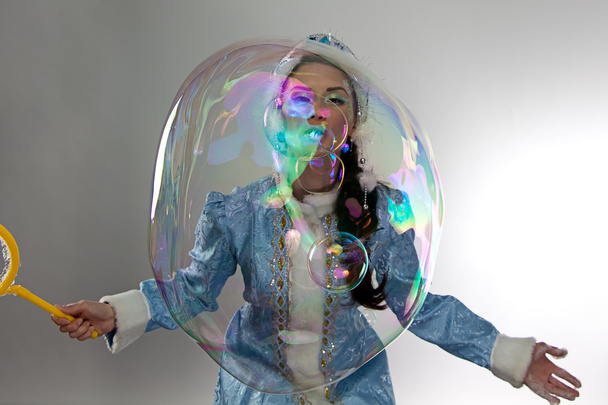 Portrait beautiful snow maiden with soap bubbles - Фото, изображение