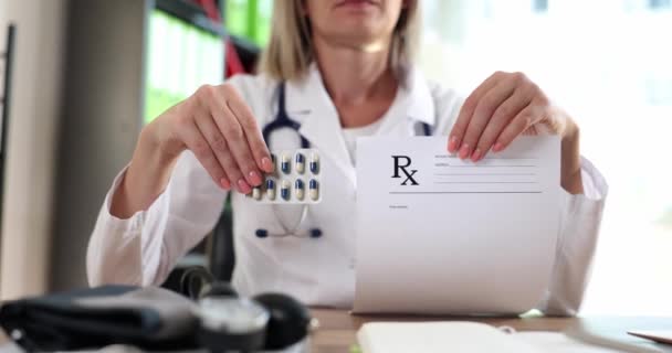 Doctor holding form with prescription and blister of medicines in clinic closeup 4k movie slow motion. Prescription drug dispensing concept - Footage, Video